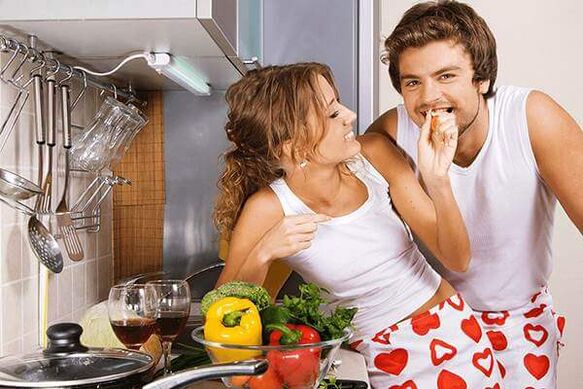 A woman feeds a man products for potency